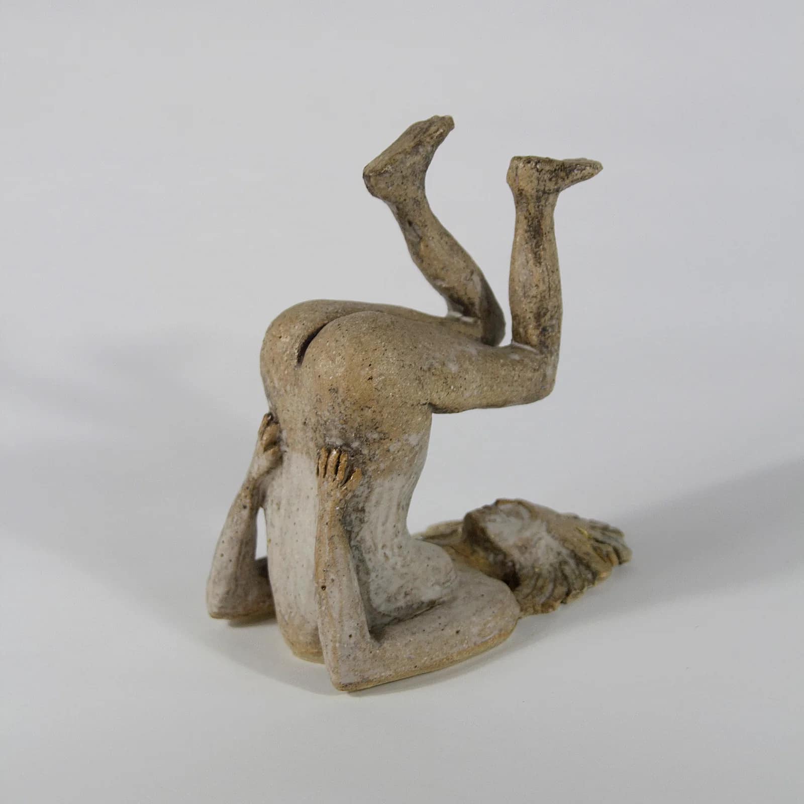 GIRL UPSIDE DOWN — Pit fired ceramic, 12cm x 8cm. Ceramic work by Dubravka Sabljak. View 1 of 2.